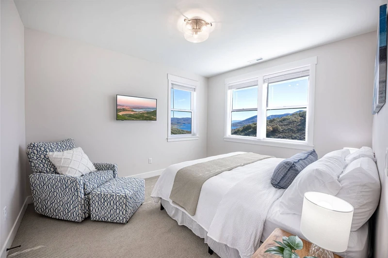 This king suite offers endless views of the mountains and the Jordanelle Reservoir and shares a bathroom with one other bedroom on the upper floor