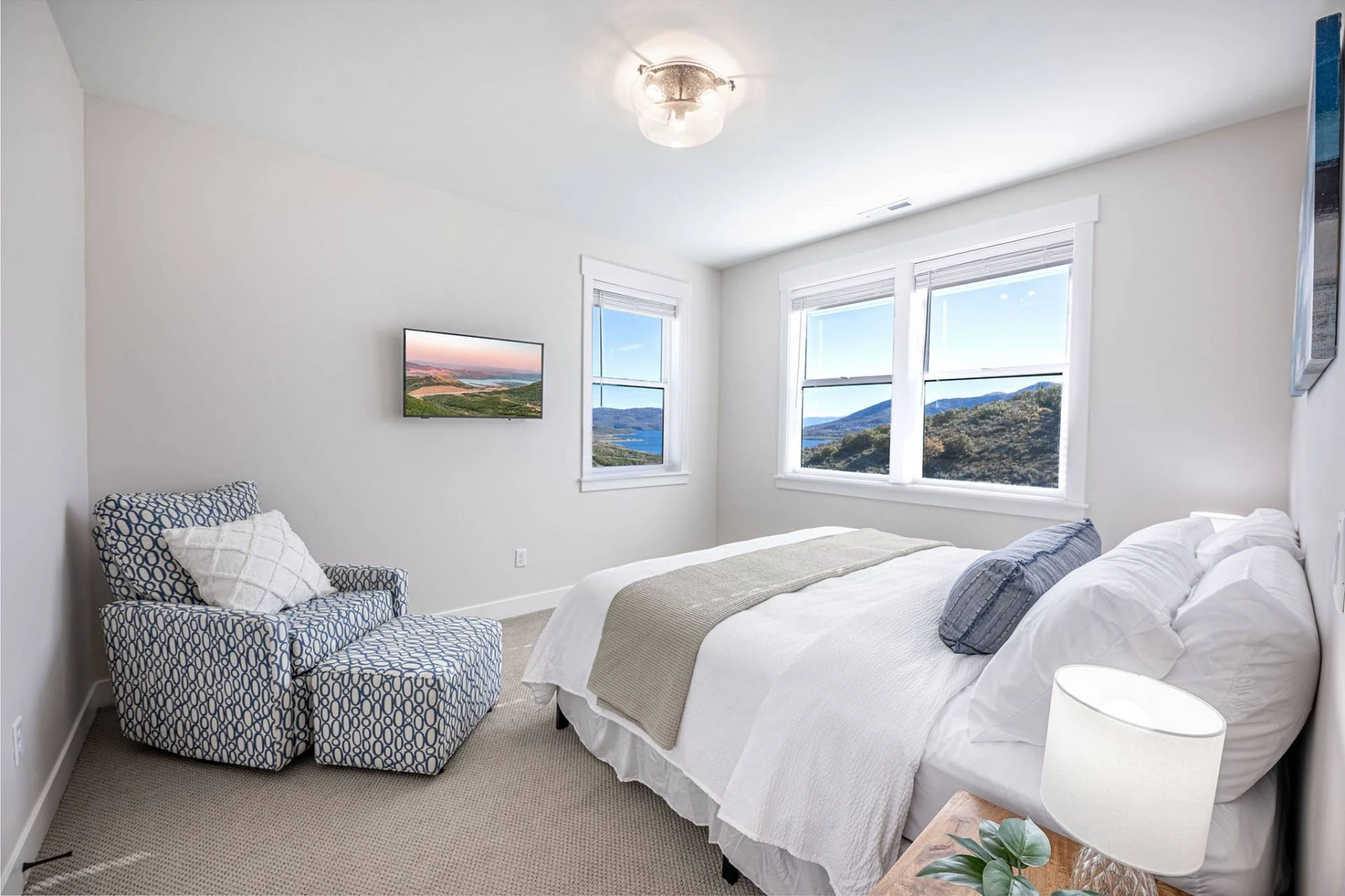 This king suite offers endless views of the mountains and the Jordanelle Reservoir and shares a bathroom with one other bedroom on the upper floor