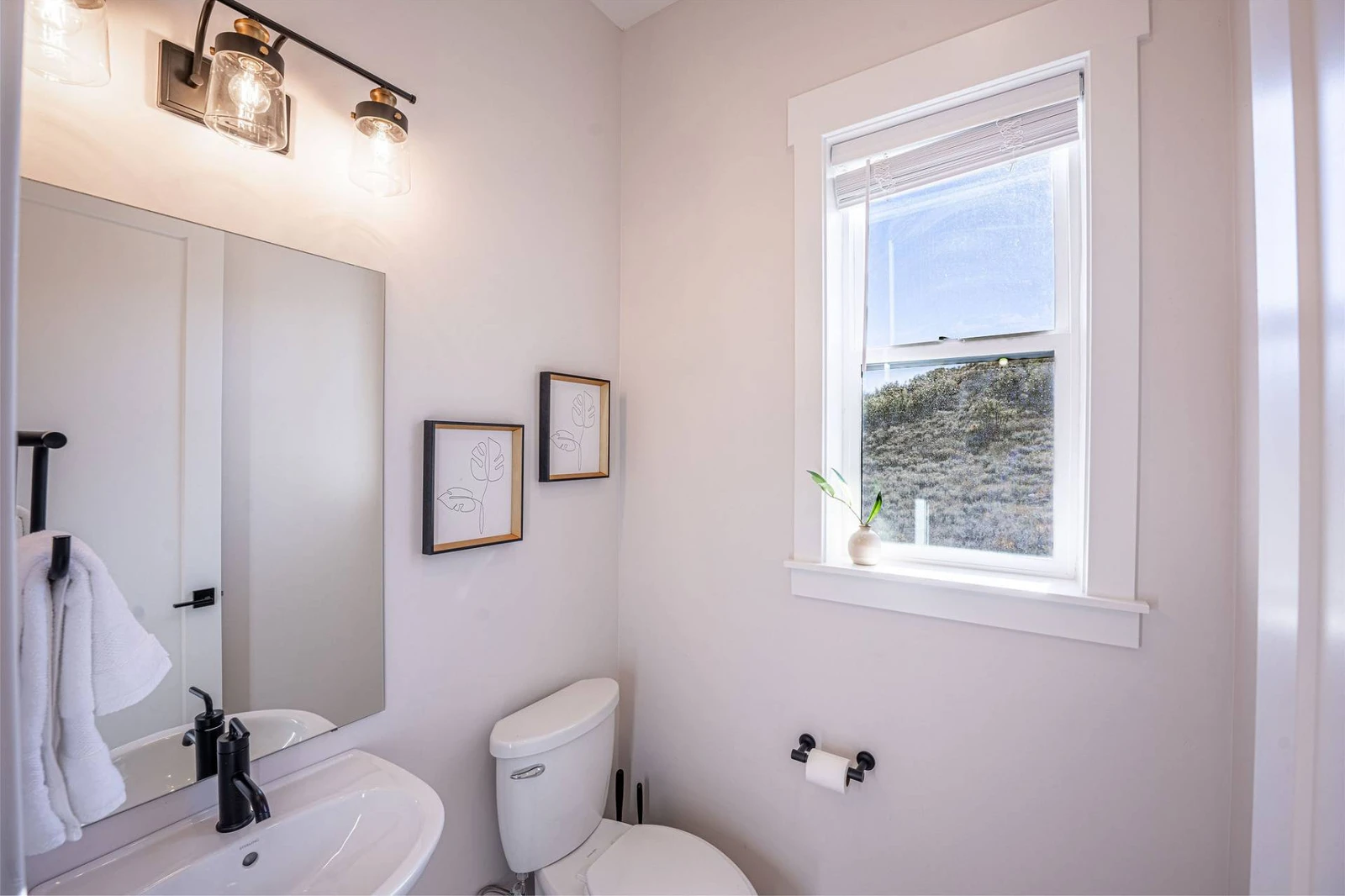 The half bathroom is located off the kitchen of the home.