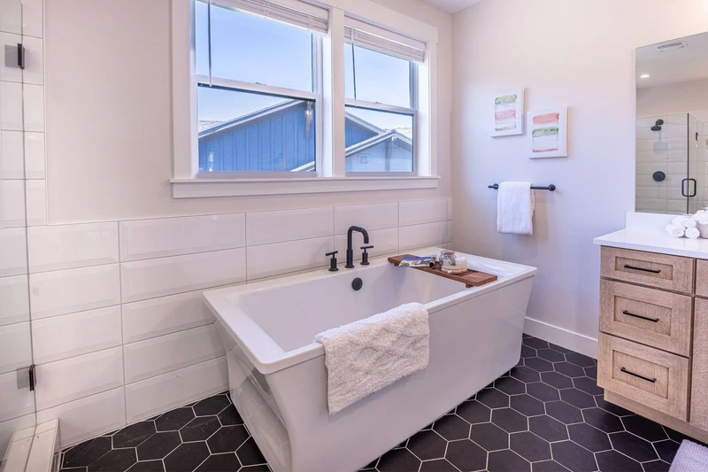 Your private oasis awaits in this stunning en suite primary bathroom with an oversized freestanding bathtub