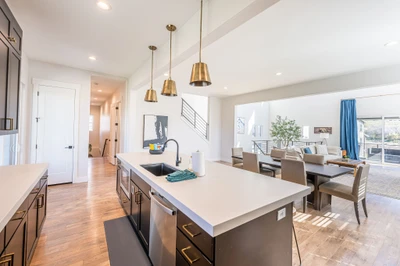 Large gourmet kitchen with breakfast bar seating at The Gathering House near Deer Valley East Village, designed for multigenerational family vacations, group meals, and gathering comfortably after skiing in Park City.