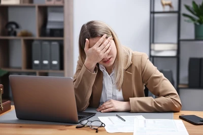 overwhelmed woman at desk