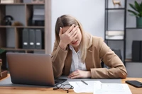 overwhelmed woman at desk