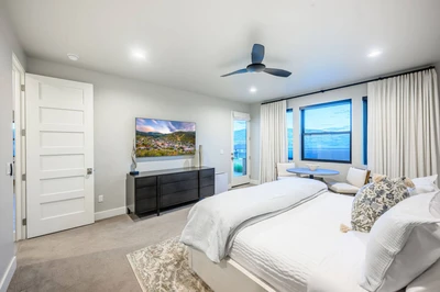 This Park City vacation home has 2 Primary suites; this one is located on the main floor. It features private patio and hot tub access.