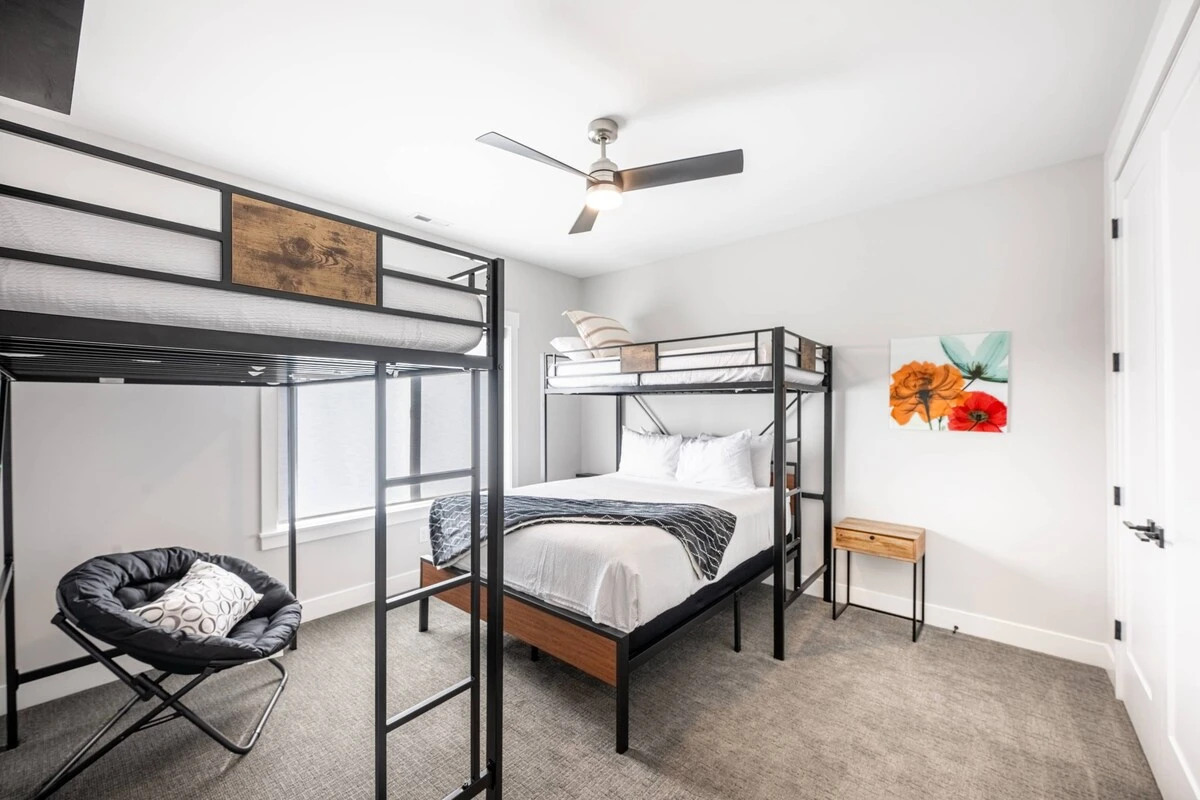 The upstairs guest suite features a twin sized bunk bed over a full sized bed. In addition there is a queen sized loft bed in this room
