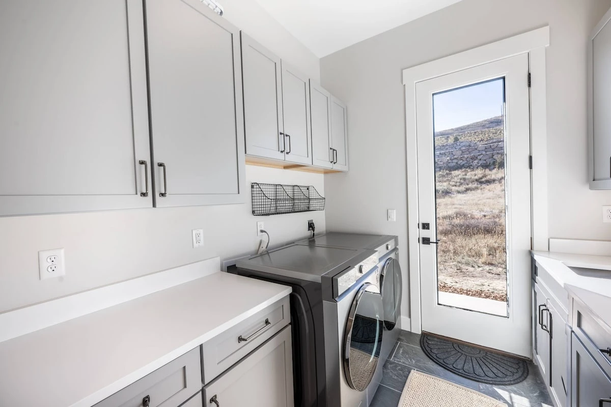 The private laundry room has a large washer and dryer for guest use and leads right to the private hot tub