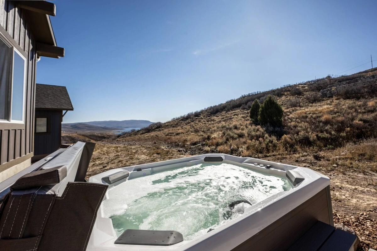 The private hot tub is located just outside your backdoor and features views of the mountains and Jordanelle Reservoir