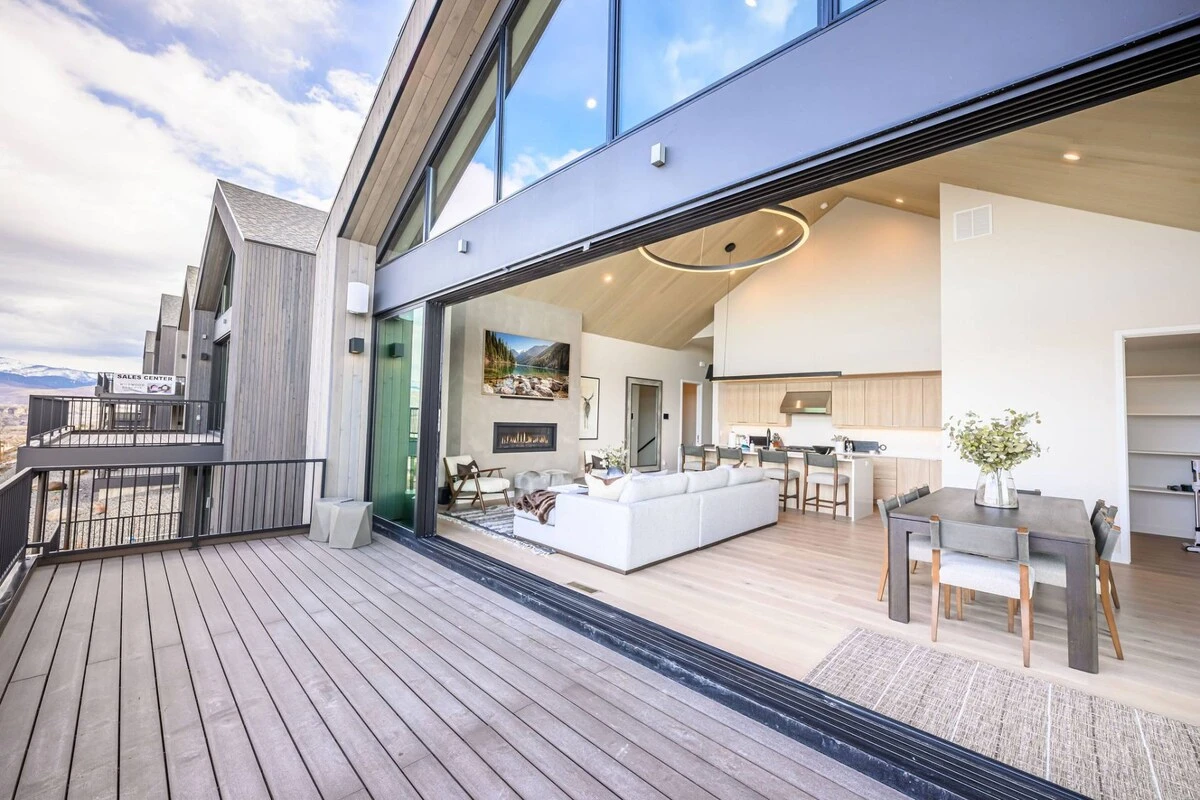 Indoor-outdoor living space with retractable glass wall and deck overlooking Jordanelle Valley
