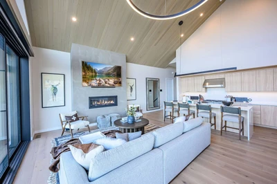 Modern mountain living room with fireplace and panoramic Wasatch Range views