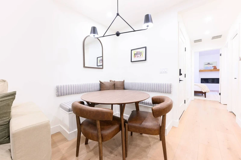 Dining table with seating beside the kitchen and living area.