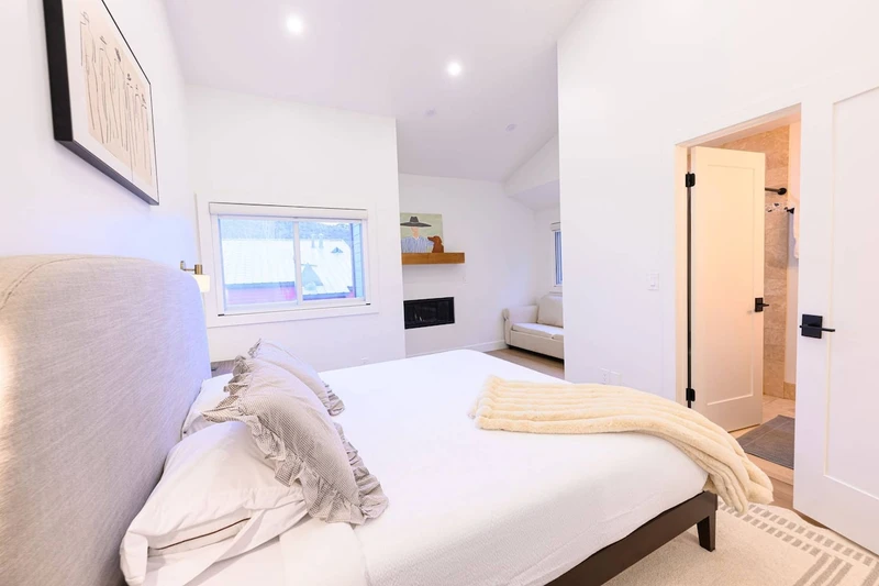 Primary Suite with king size bed and attached bathroom.