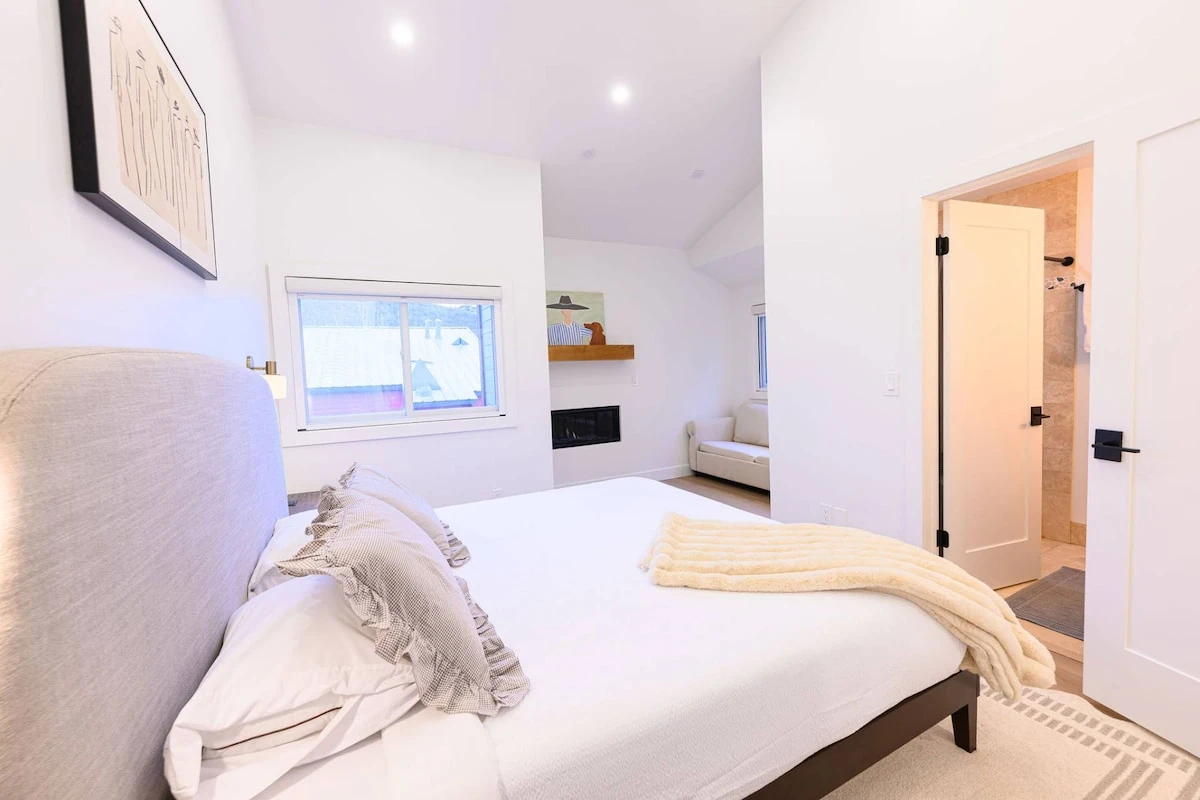 Primary Suite with king size bed and attached bathroom.