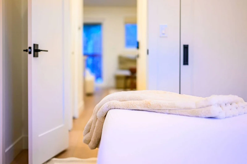 Beds made with clean, triple-sheeted bedding.