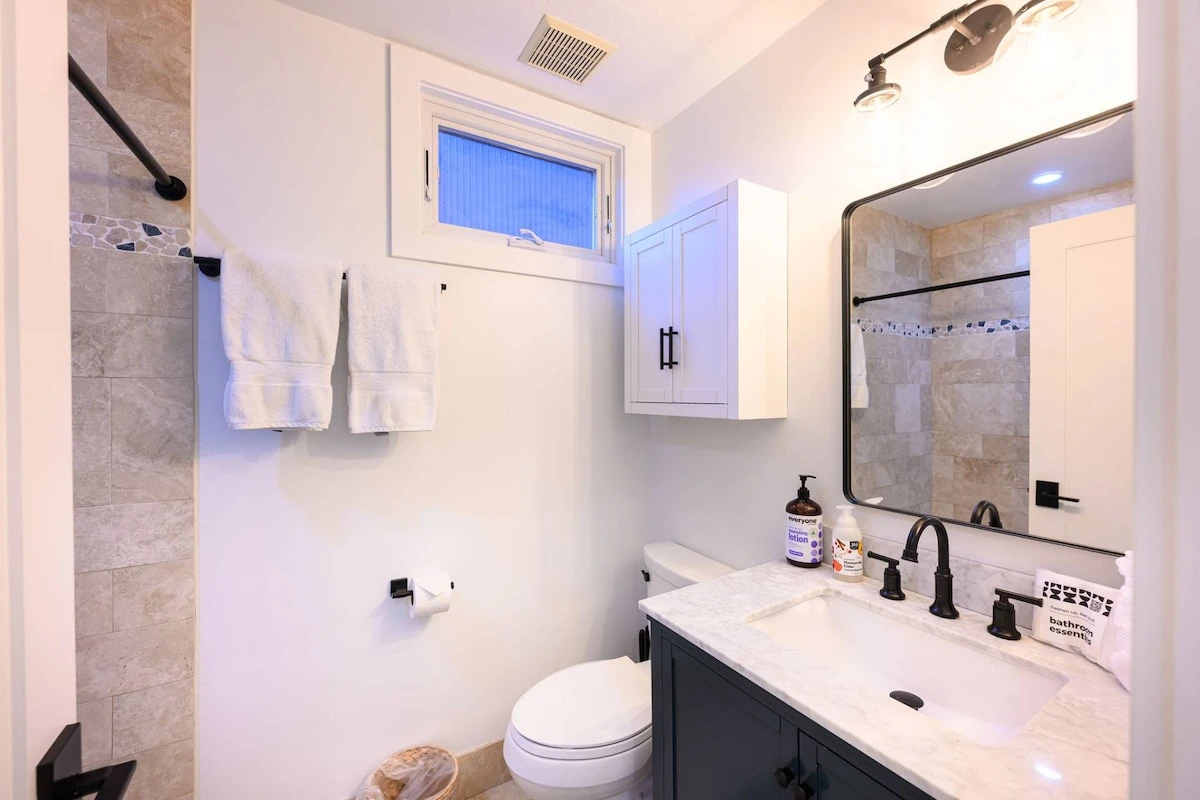 Bathroom with fresh towels and standard amenities.