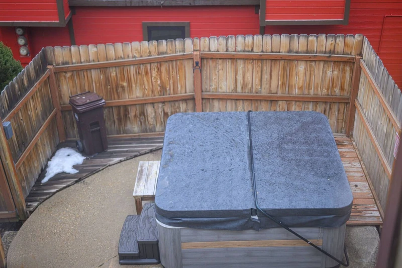 Private balcony with hot tub and outdoor space.
