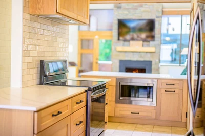 Fully stocked, recently updated kitchen with stainless steel appliances overlooking the living room