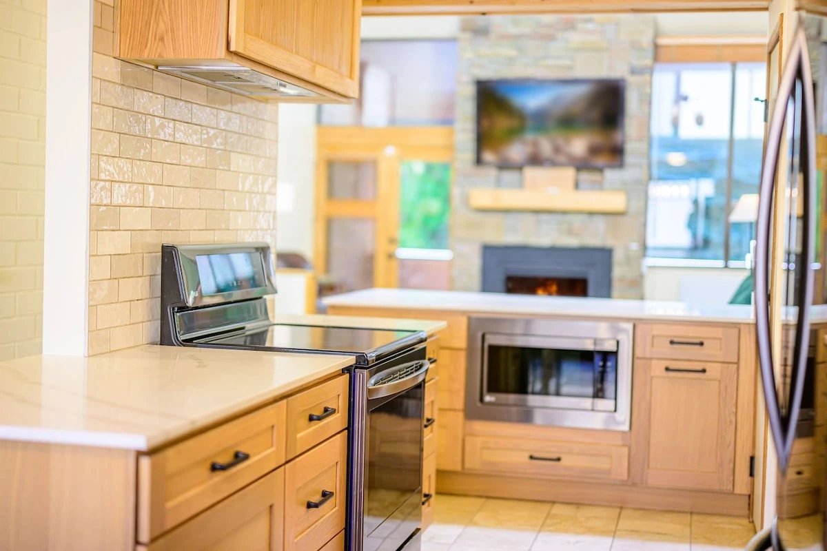Fully stocked, recently updated kitchen with stainless steel appliances overlooking the living room