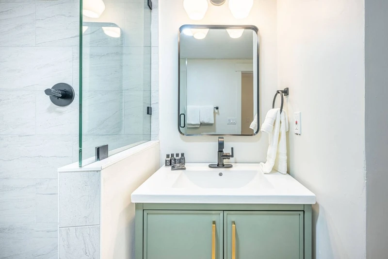 Brand new high end bathroom with fresh towels and standard amenities.
