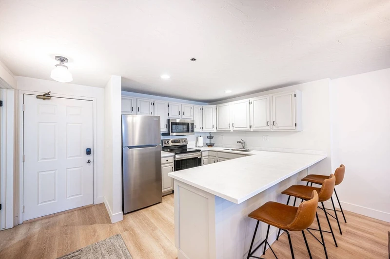 Kitchen island with additional prep space and casual seating.
