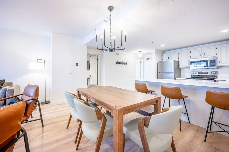 Dining area with table seating, located adjacent to the kitchen and living space.