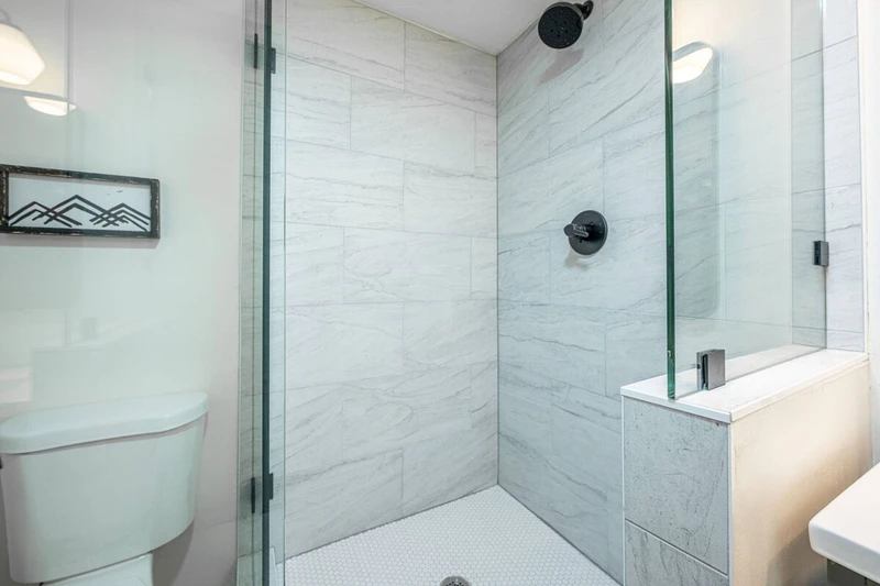 Walk-in glass shower with new tile