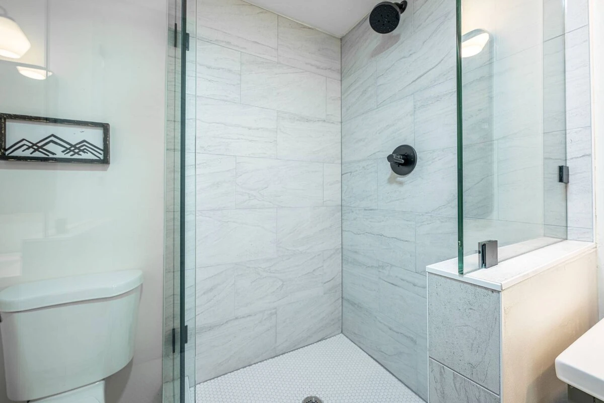 Walk-in glass shower with new tile
