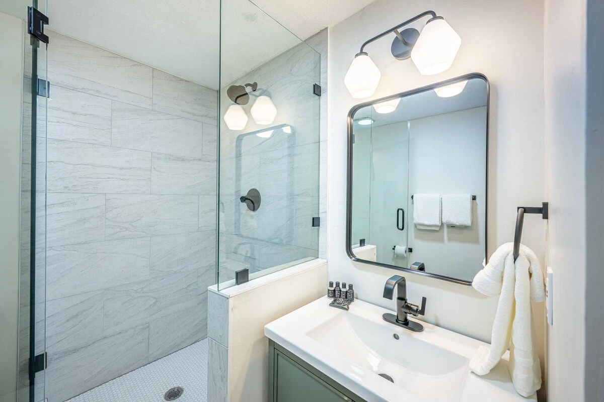 Full bathroom with modern vanity and walk in glass shower.