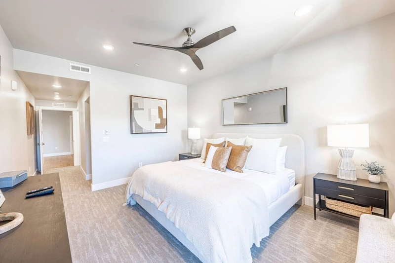 Bright primary bedroom with king bed and modern furnishings in Mayflower Lakeside Park City vacation rental.”
