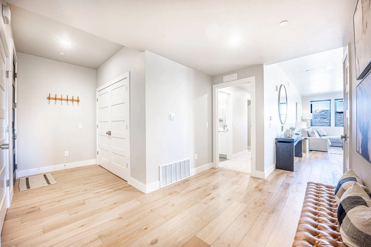 Bright hallway leading to bedrooms in modern 3-bedroom Deer Valley East condo at Mayflower Lakeside