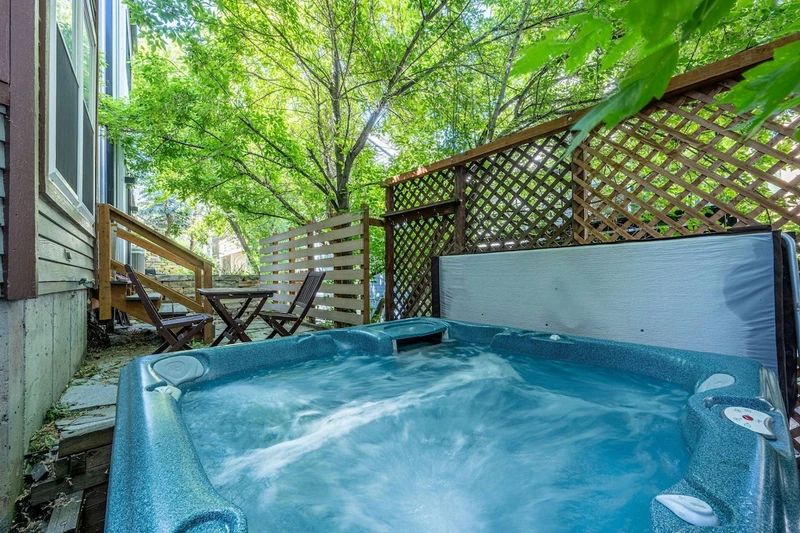 Private outdoor hot tub surrounded by trees, perfect after skiing at Park City Mountain.