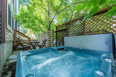 Private outdoor hot tub surrounded by trees, perfect after skiing at Park City Mountain.