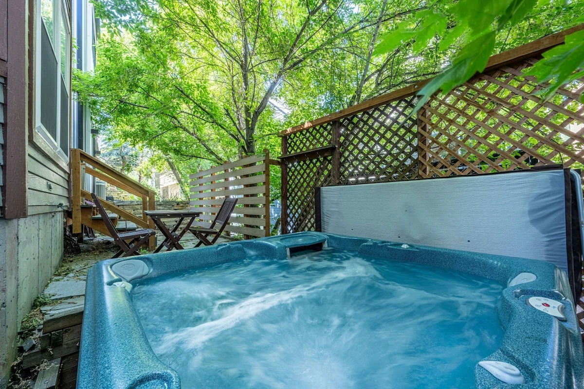 Private outdoor hot tub surrounded by trees, perfect after skiing at Park City Mountain.