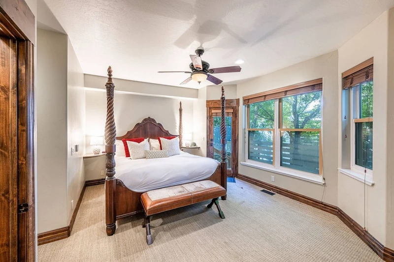 Primary bedroom with king bed and large windows overlooking the Old Town neighborhood.