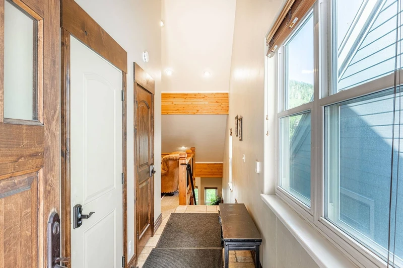 The entryway has benches with ski storage available in the garage.
