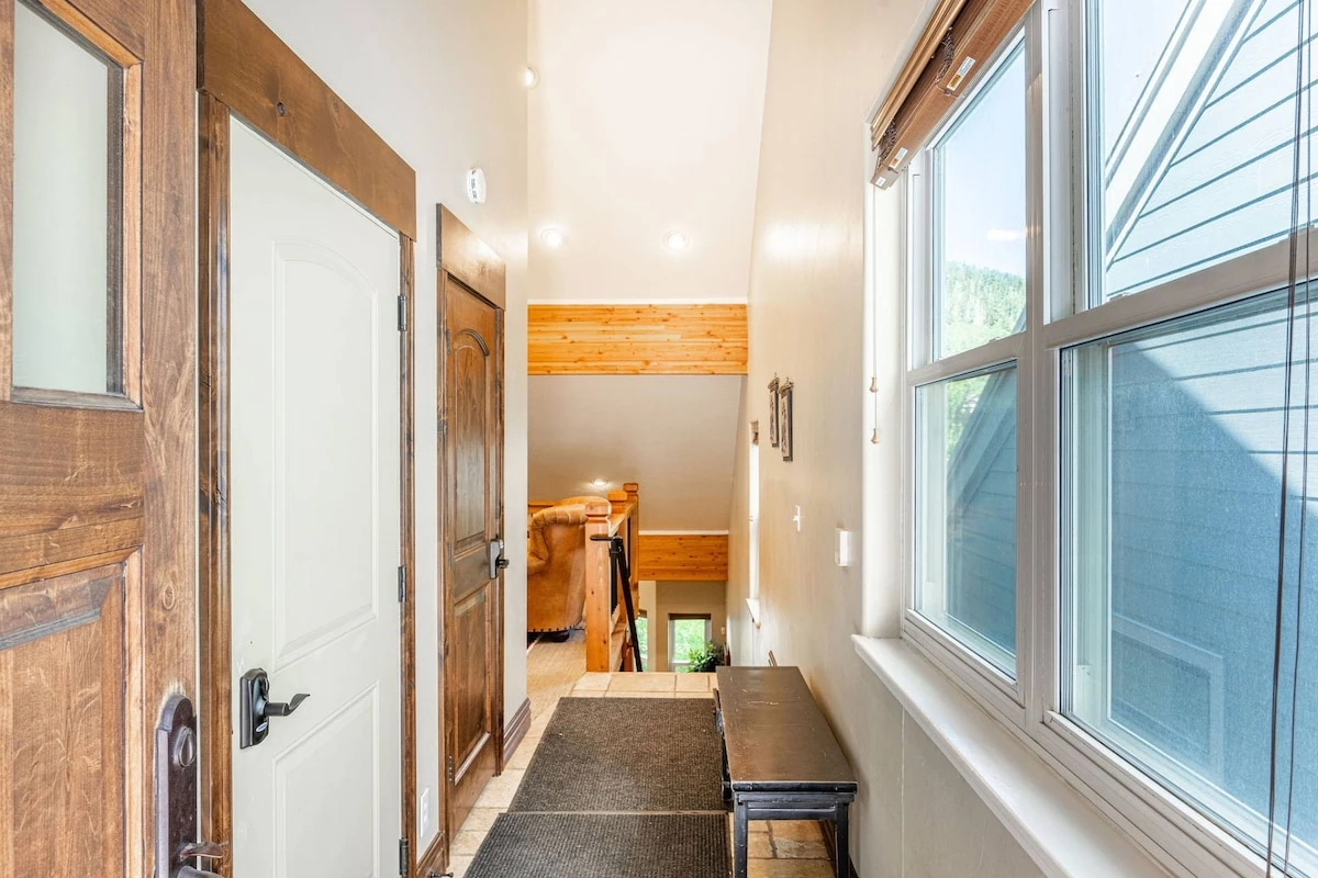 The entryway has benches with ski storage available in the garage.