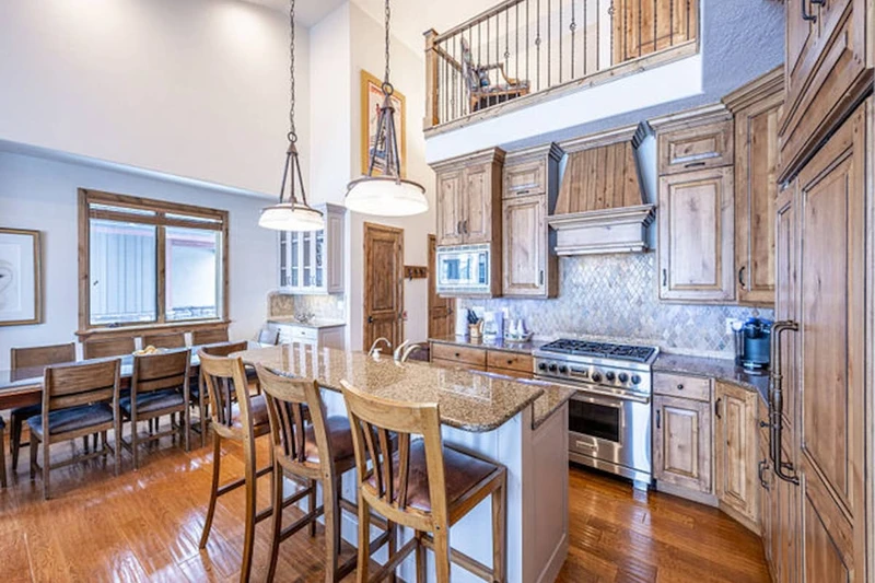 The primary kitchen features a breakfast bar, upgraded stainless steel Viking and Wolf appliances.