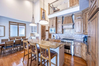 The primary kitchen features a breakfast bar, upgraded stainless steel Viking and Wolf appliances.