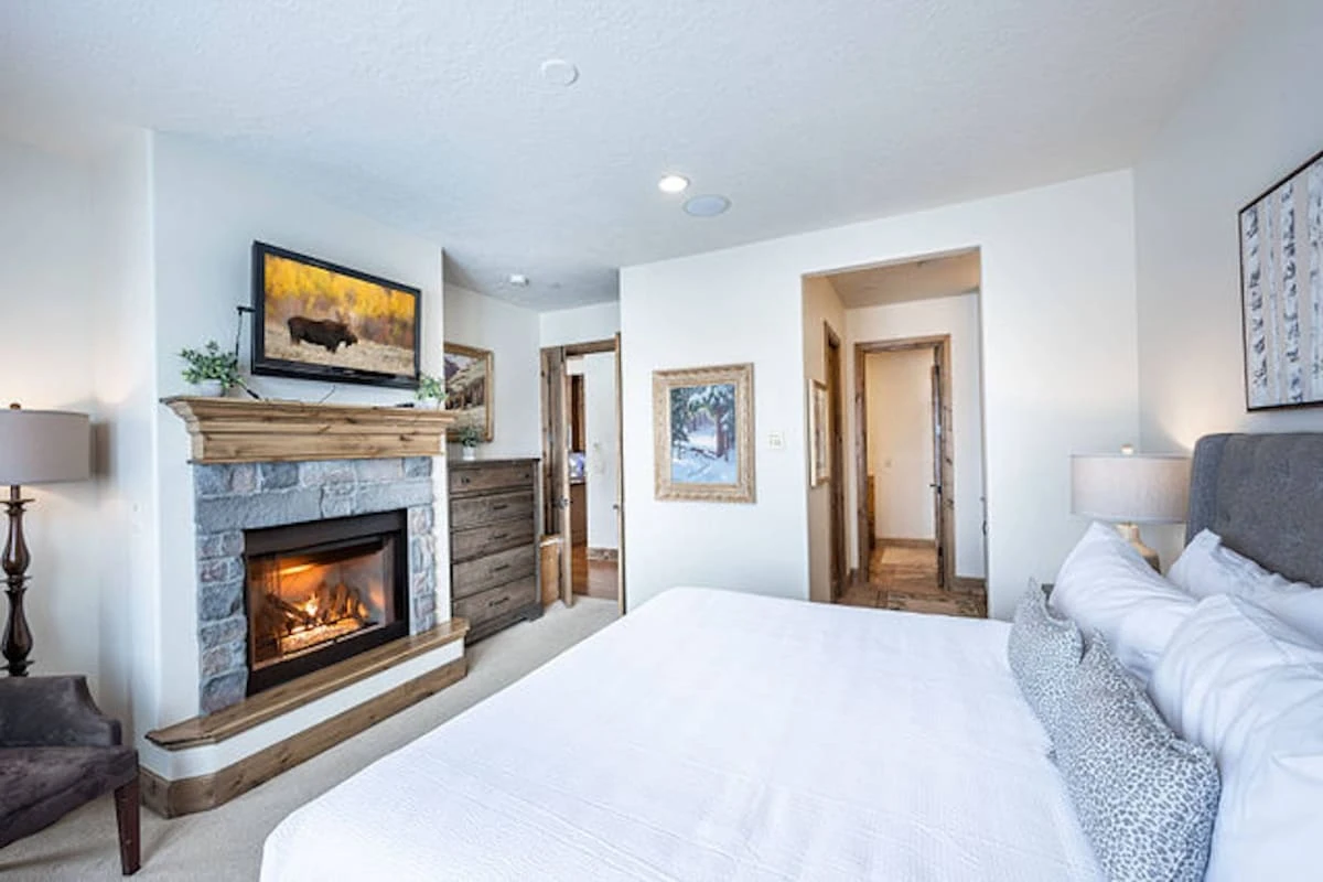 Alternate view of Main Level Primary suite with King bed, gas fireplace, hdtv and views.