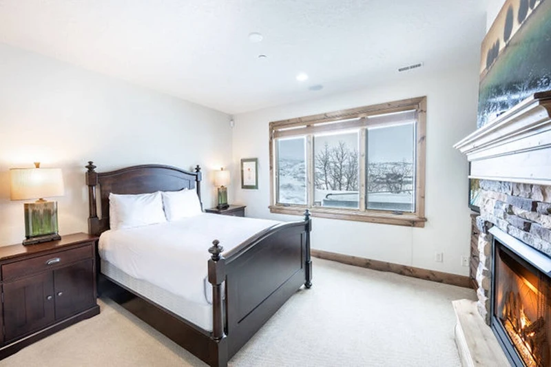 Lower level king bedroom with hdtv, gas fireplace, views and easy hot tub access