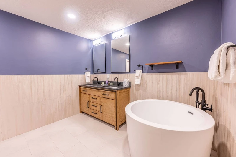 The Primary en-suite bathroom features a deep Japanese soaking tub (ofuro) for a relaxing soak after skiing or hiking. A spa-style bathroom in this renovated top-floor penthouse at The Prospector in Park City, Utah