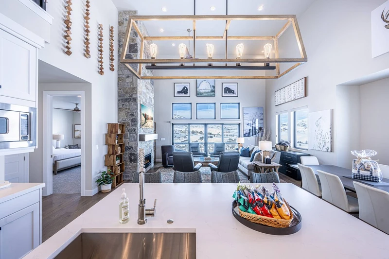 Open space living area infused with morning sunlight and views of the mountains