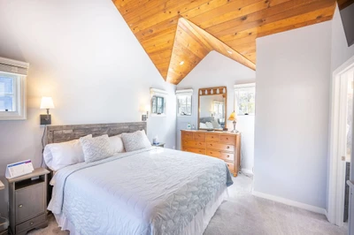 Located on the Upper Level is the Primary Suite  Vaulted Ceilings, HDTV and En Suite Bathroom– It is A Perfect Retreat