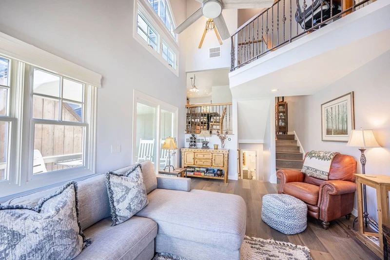 The warm and inviting family room has gorgeous views, vaulted ceiling new HDTV, new fireplace, leather  chair and comfortable upholstered L-shaped sof
