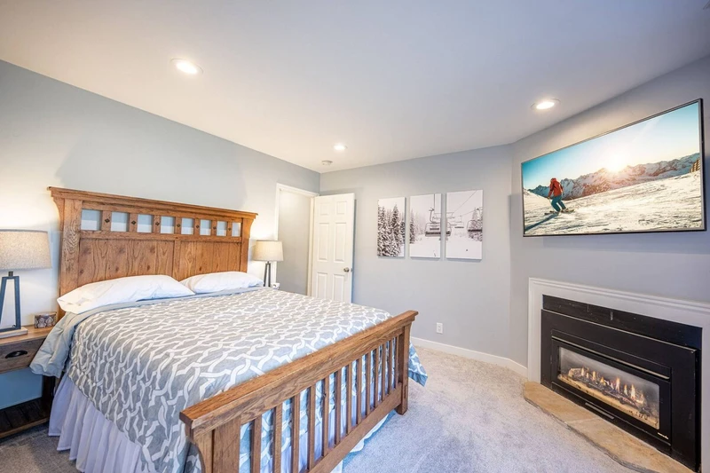 The warm and welcoming lower level guest suite is a perfect retreat with a private fireplace, hot tub access and comfortable queen bed