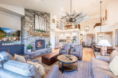 This spacious living room has vaulted ceilings, a large gas fireplace, and open floor plan to the kitchen.