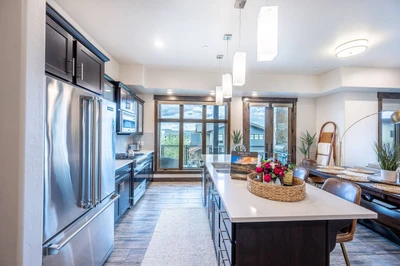The all new, fully stocked chef's kitchen has stainless steel appliances including a gas range and french door fridge