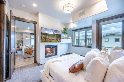 Located off the living room, the bright and cheery guest suite has a King bed, gas fireplace and oversized HDTV, new king sized bed, and queen sized d