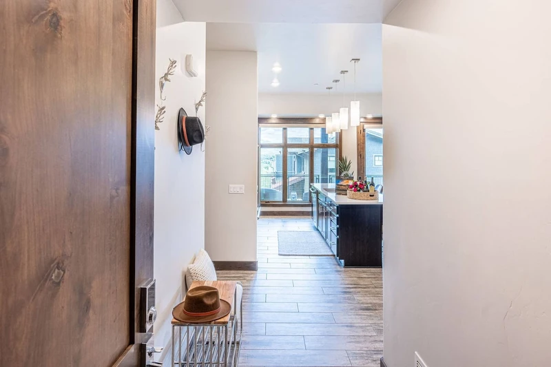 Convenient bench and shoe storage are featured in the large entryway