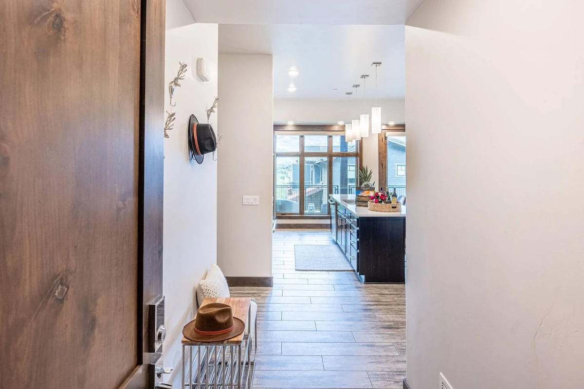 Convenient bench and shoe storage are featured in the large entryway