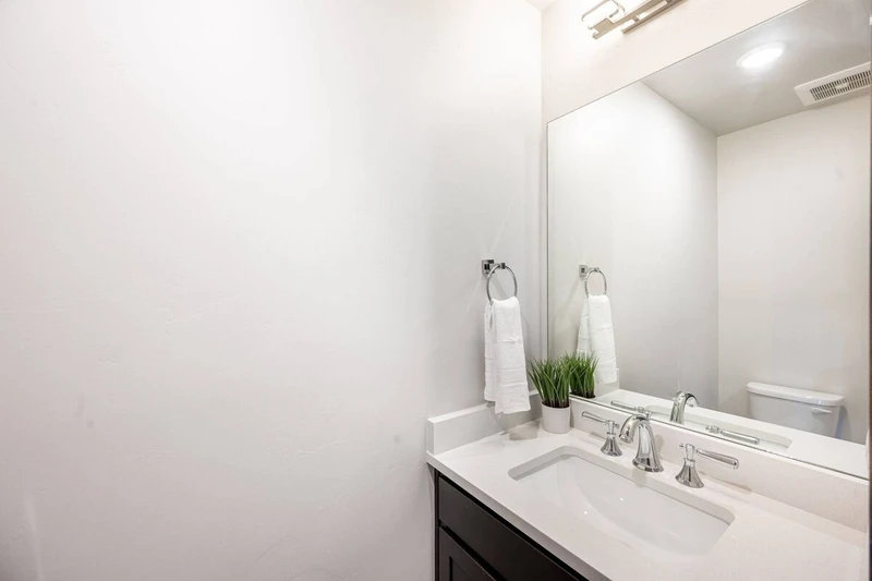 Guests will enjoy the half bathroom just off the entrance of the home